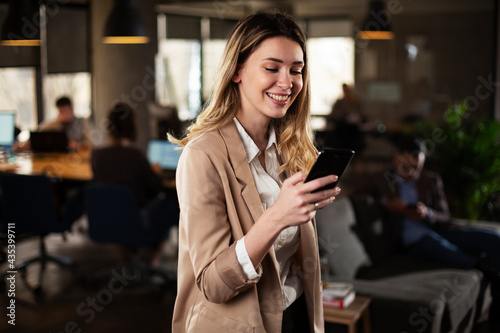 Businesswoman in office. Smiling businesswoman using the phone..