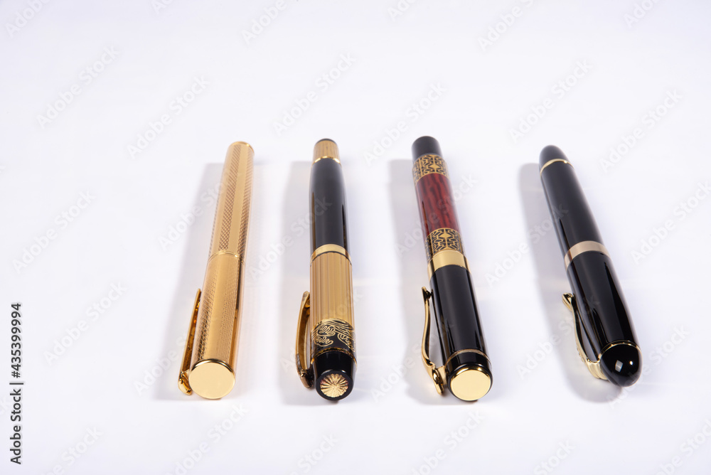 Fountain pen, four beautiful fountain pens in detail on white background, selective focus. Fountain pen, four beautiful fountain pens in detail on white background, selective focus.