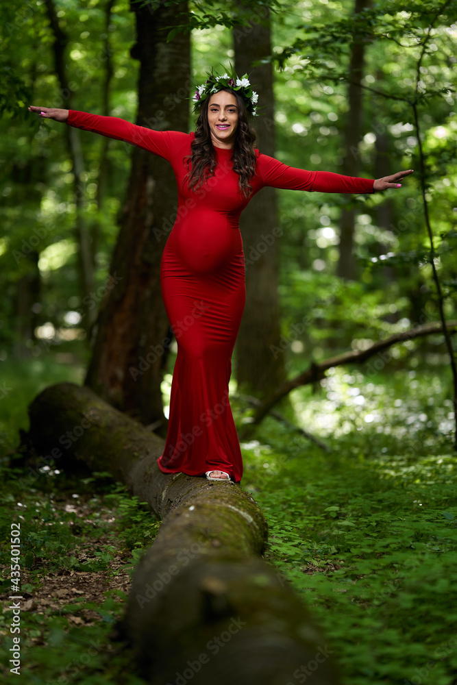 Beautiful latino pregnant woman in the forest
