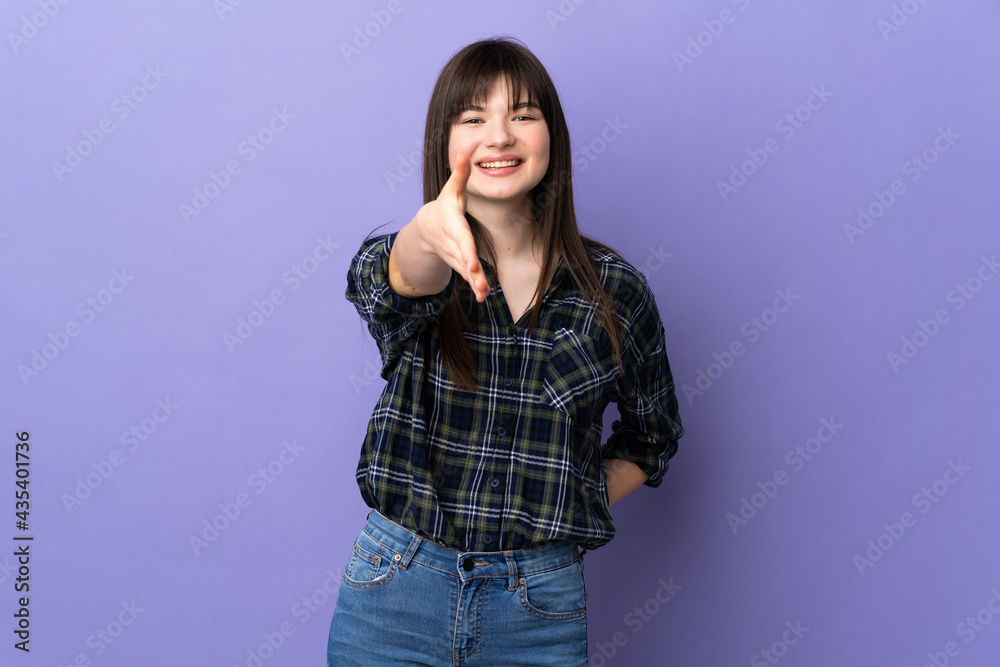 Young Ukrainian woman isolated on purple background shaking hands for closing a good deal Young Ukrainian woman isolated on purple background shaking hands for closing a good deal