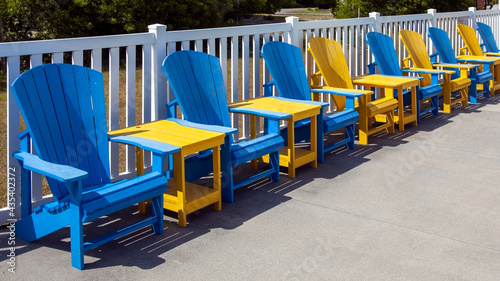 Blue pool chairs with yellow tables.