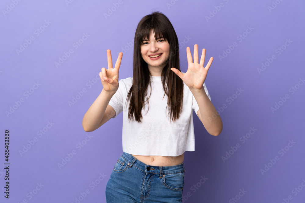 Young Ukrainian woman isolated on purple background counting seven with fingers