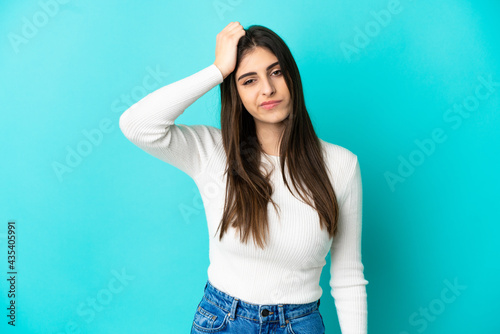 Young caucasian woman isolated on blue background with an expression of frustration and not understanding