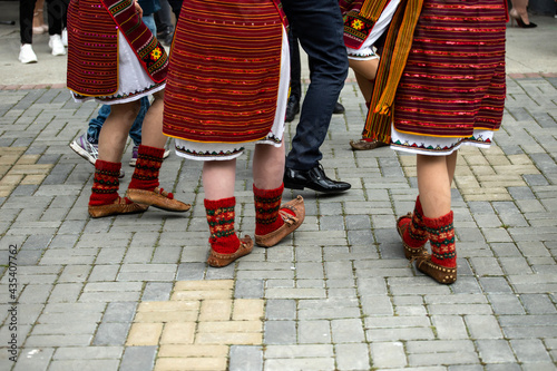 Ukrainian national clothing - embroideries. Young people in embroidered shirts dance. 