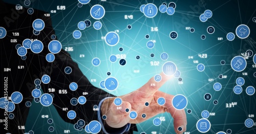 Composition of businessman touching screen with network of digital icons