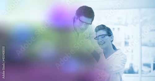 Composition of male and female scientists in laboratory with blurred spots