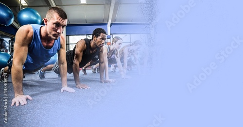 Composition of fit men and woman doing press ups in gym with blue blur