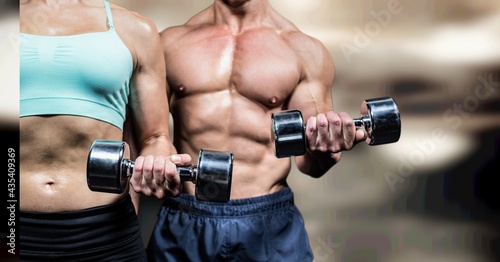 Composition of strong caucasian woman and man lifting dumbbells with copy space