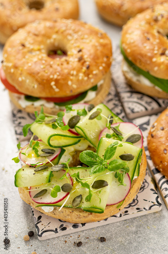 Fresh healthy sandwiches with seeded bagel, slad and cotage cheese