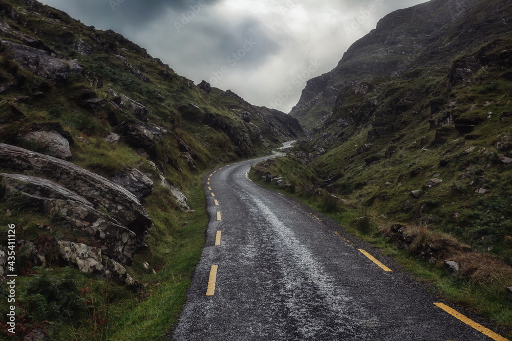 mountain road in County Kerry Ireland, dramatic and cloudy sky