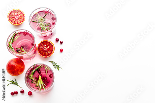 Fototapeta Naklejka Na Ścianę i Meble -  Cold cocktails in glasses with cranberry and blood orange grapefruit