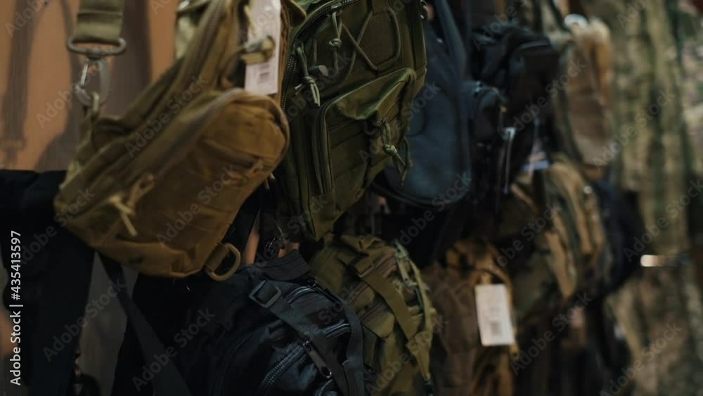 military clothing store. Hangers with clothes and bags military clothing store. Hangers with clothes and bags