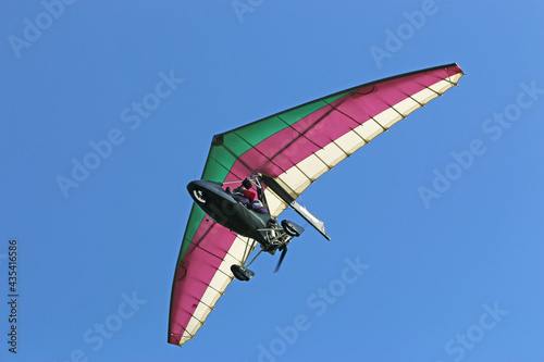 Canvas-taulu Ultralight airplane flying in a blue sky