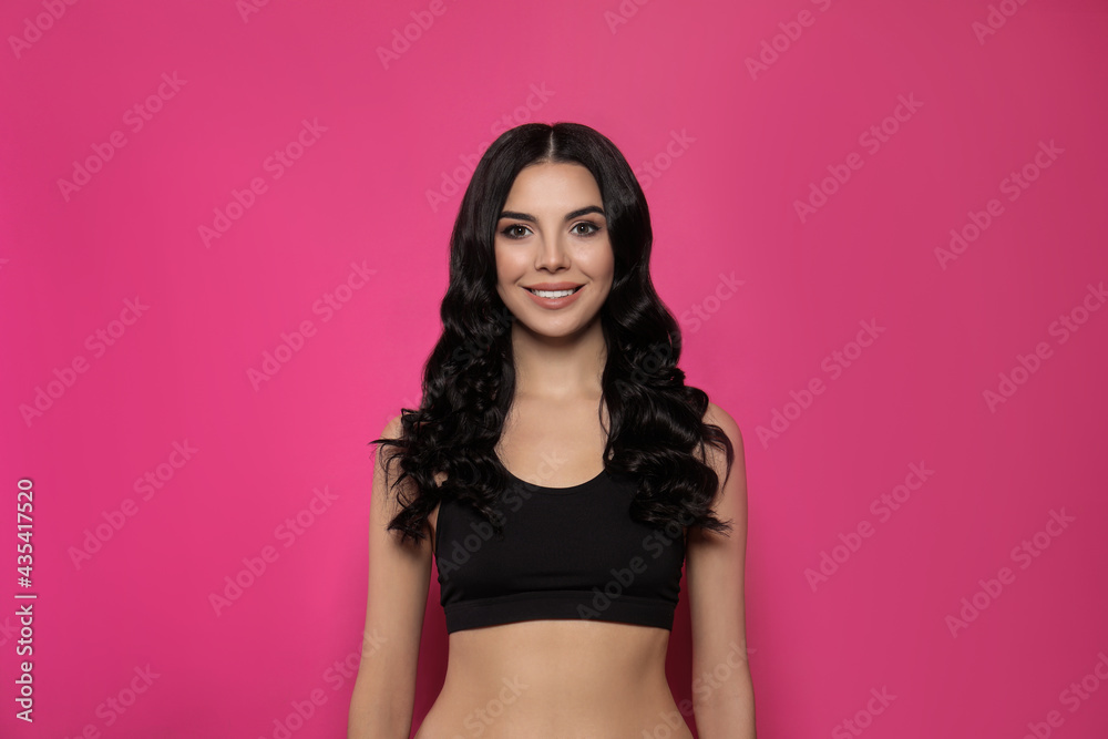 Beautiful young woman with long curly hair on pink background Beautiful young woman with long curly hair on pink background