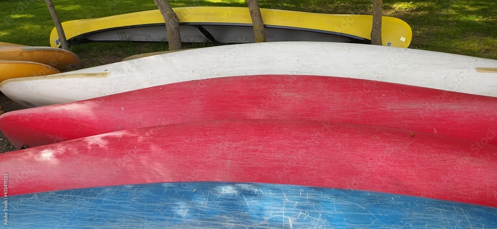 Canoes on the shore waiting for children in the summer camp