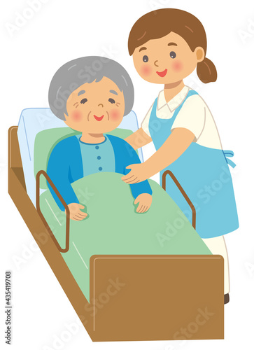 介護用ベッドで介護されている高齢の女性と、女性の介護者