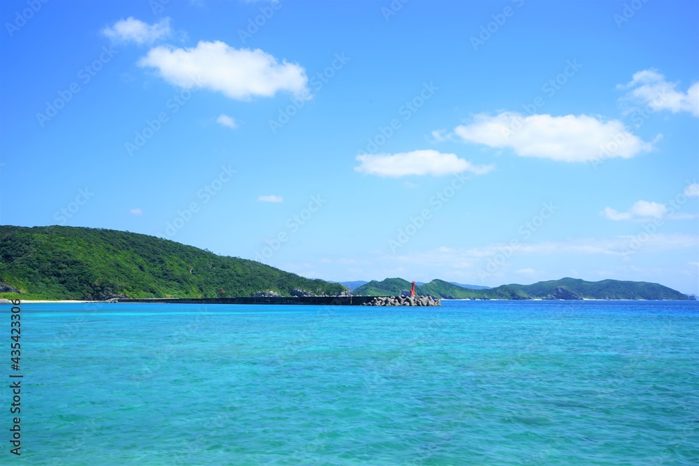 Beautiful summer scenery of Zamami port pier with lighthouse in Okinawa, Japan - 日本 沖縄 座間味港 ピア 青い海	