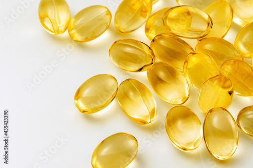 Colse up of Vitamin E capsules on white background.