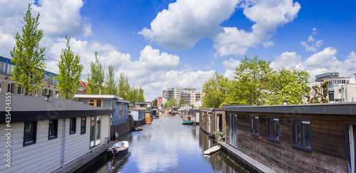 Panorama of wooden houseboats in the canal in Groningen, Netherlands