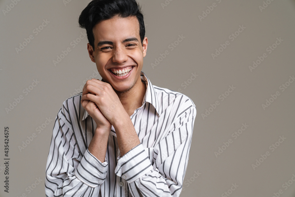 Fototapeta premium Brunette hispanic man in shirt laughing and looking at camera