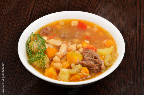 soup with meat, potatoes, pumpkin, vegetables and dill