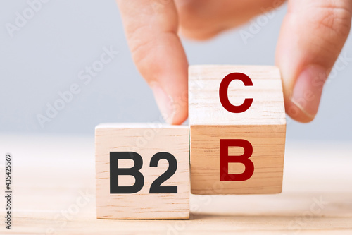 hand change wooden cube block from B2C to B2B. E Commerce, marketing and strategy concepts photo