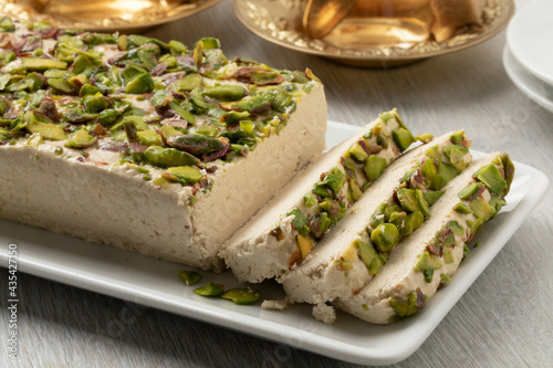 Plate with traditional Turkish pistachio halva and slices close up   photo