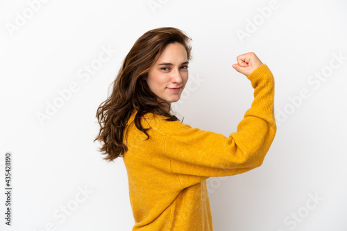 Young caucasian woman isolated on white background doing strong gesture © luismolinero