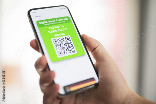 Digital green card certificate with covid-19 immune on smartphone screen