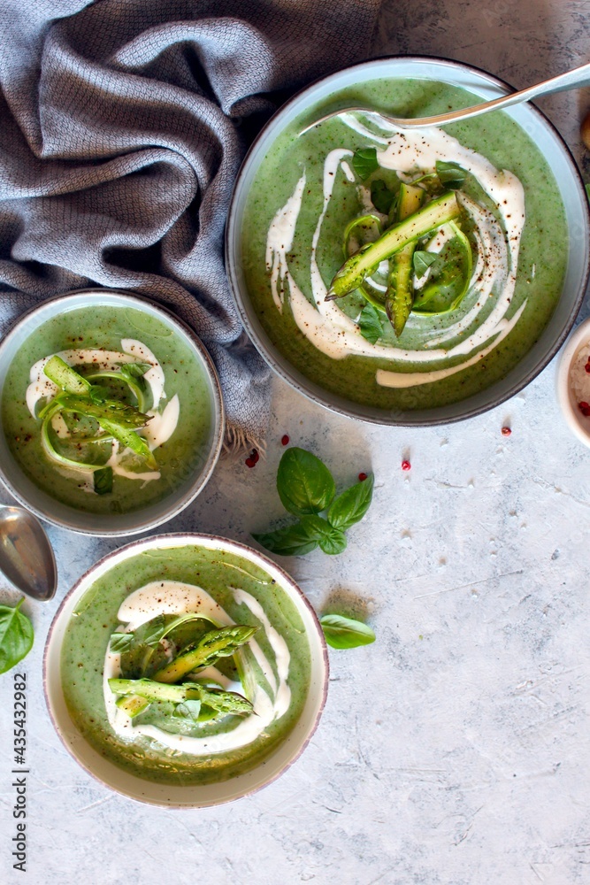 Obraz premium Asparagus and potato cream soup on light background. Top view with copy space. Healthy food.