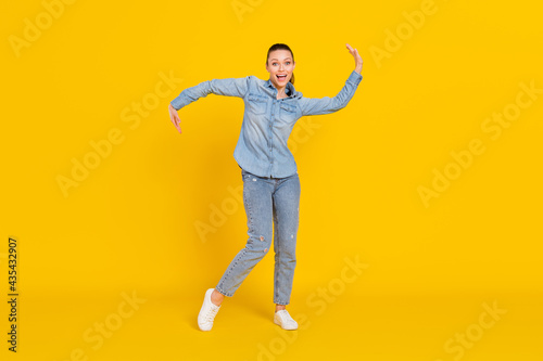 Full length body size photo cheerful careless girl dancing at party relaxing on weekend isolated bright yellow color background