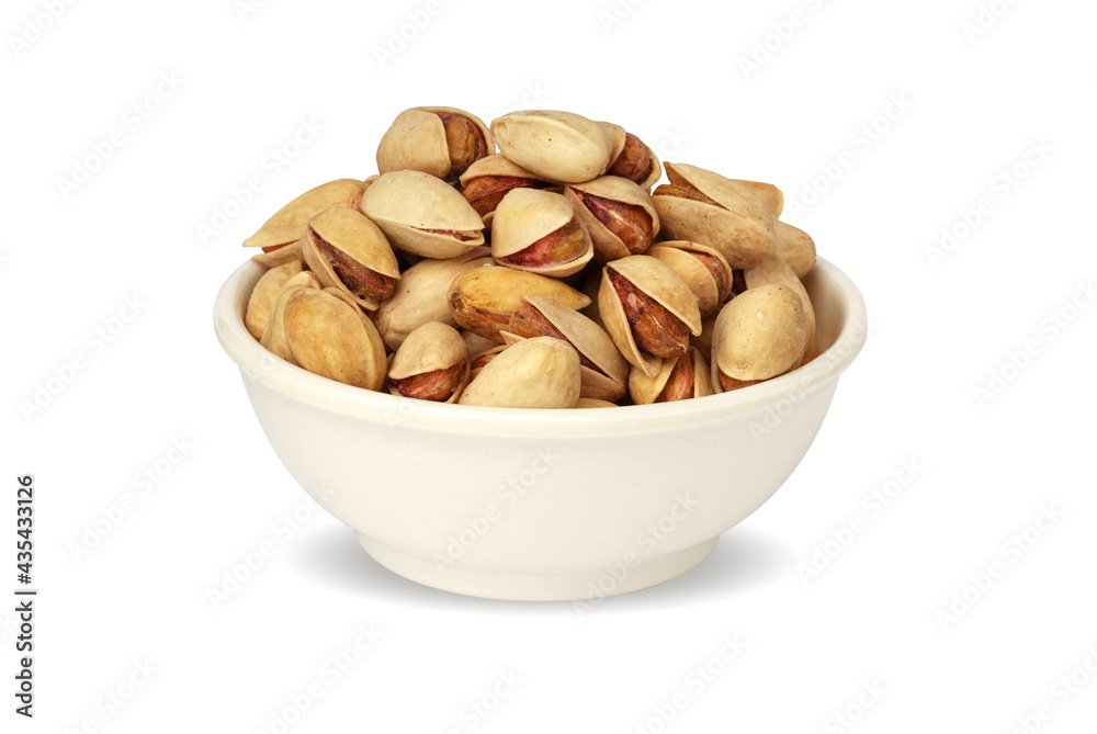 pistachios in a white plate isolated on a white background. pistachios in a white plate isolated on a white background.