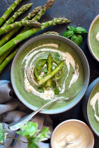 Asparagus and potato cream soup on light background. Top view with copy space. Healthy food.