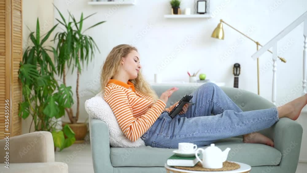 Home school online student. spbas using tablet on comfortable sofa Home school online student. spbas using tablet on comfortable sofa