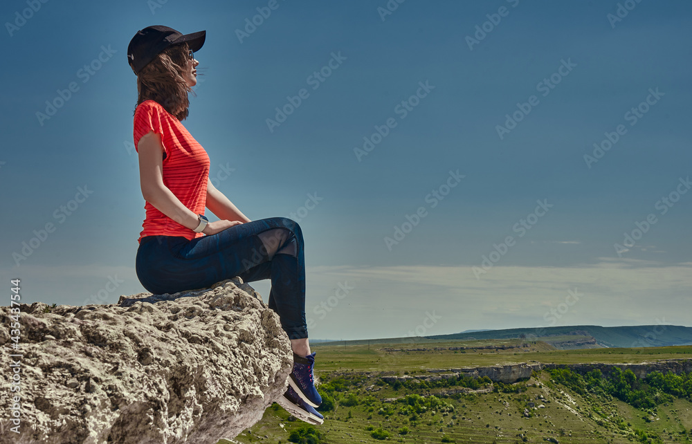 girl in sportswear at the top of the mountain