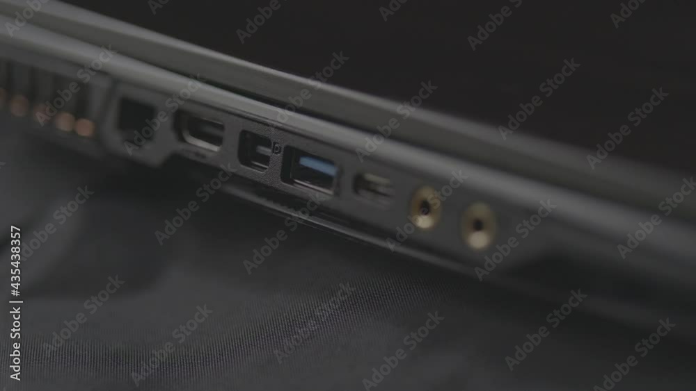 Black Laptop on Black Cloth Side view Close up HDMI Microphone USB Earphone