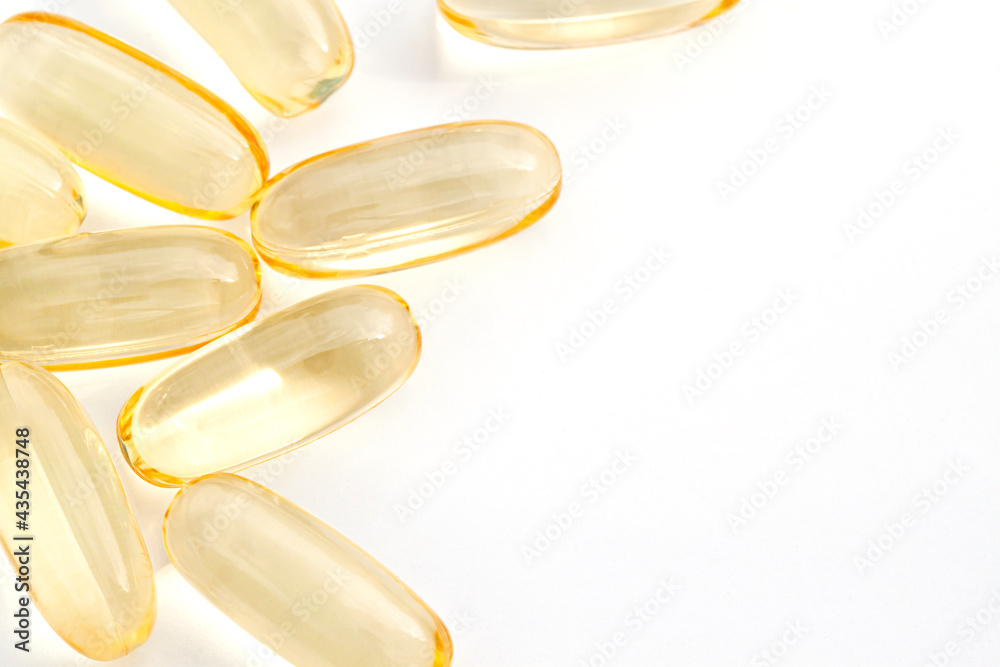 Dietary supplement Omega 3 fish oil capsules on the white background close up Dietary supplement Omega 3 fish oil capsules on the white background close up