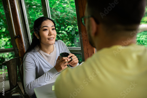 Couple sitting in a coffee shop talking and drinking coffee. © Zoran Zeremski