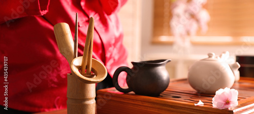 Traditional tea ceremony. Master near tools and tray, closeup photo