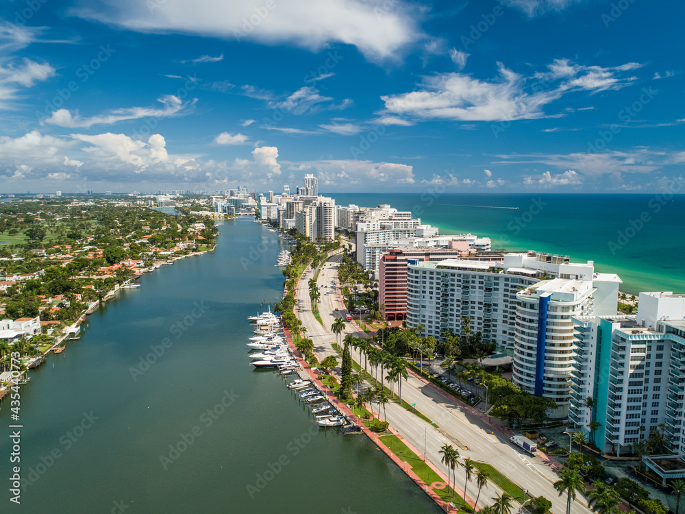 Obraz premium Aerial Miami Beach along Collins Avenue mid beach waterway with Yacht Marina and high rise condos