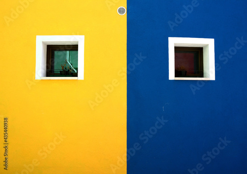 yellow wall with blue windows