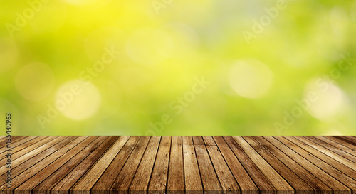 Wood floor with blurred trees of nature park background and summer season  product display montage