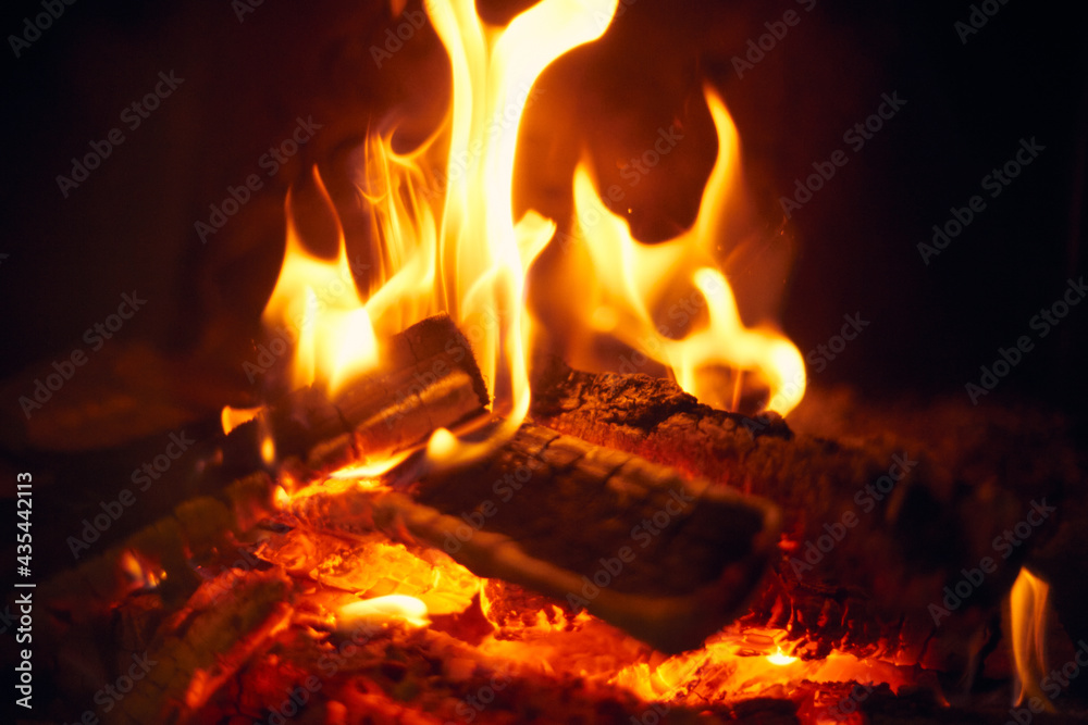 A fire burns in a fireplace, Fire to keep warm. Logs burning in a fireplace A fire burns in a fireplace, Fire to keep warm. Logs burning in a fireplace