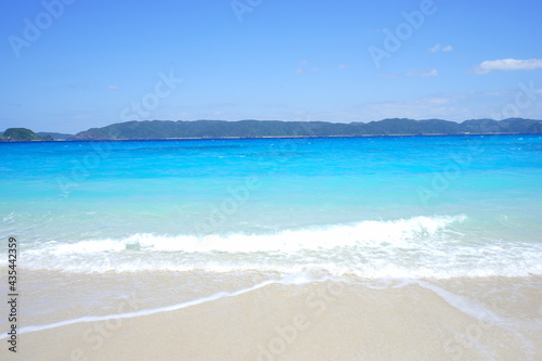 Beautiful summer scenery. calm waves on the blue water. Furuzamami Beach in Zamami island  Okinawa  Japan. Closeup -                                                           