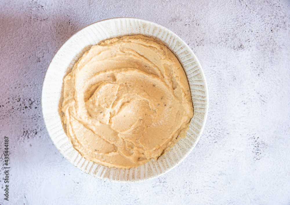 plate with hummus and chickpeas on a light gray background. plate with hummus and chickpeas on a light gray background.