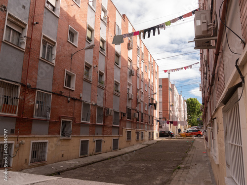 POOR NEIGHBORHOOD IN SPAIN AREA STREET WITH CLOTHES AND GARBAGE