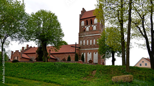 General view and architectural details in close. Catholic church dedicated to the Assumption of the Blessed Virgin Mary. Built in the second half of the 14th century in the town of Galiny, warmi in Po