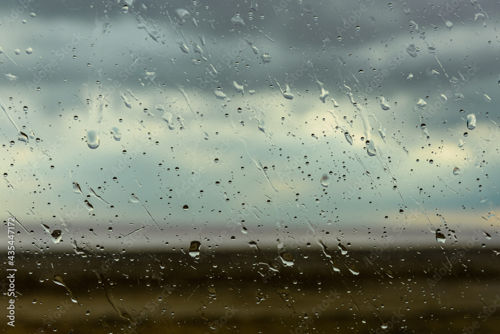 Water drops on a car glass. Raining weather Water drops on a car glass. Raining weather