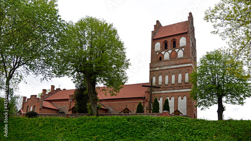 General view and architectural details in close. Catholic church dedicated to the Assumption of the Blessed Virgin Mary. Built in the second half of the 14th century in the town of Galiny, warmi in Po photo