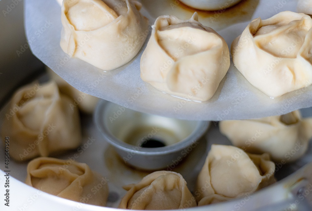 Ready-to-cook manti. Traditional meat dish of the peoples of Central Asia. Appetizing Dumpling. Ready-to-cook manti. Traditional meat dish of the peoples of Central Asia. Appetizing Dumpling.